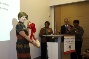 Alice Krapf receives a shovel from the grateful Board of the Mattapan Community Health Center